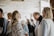 A cozy event space with soft lighting, filled with people enjoying a social gathering.
