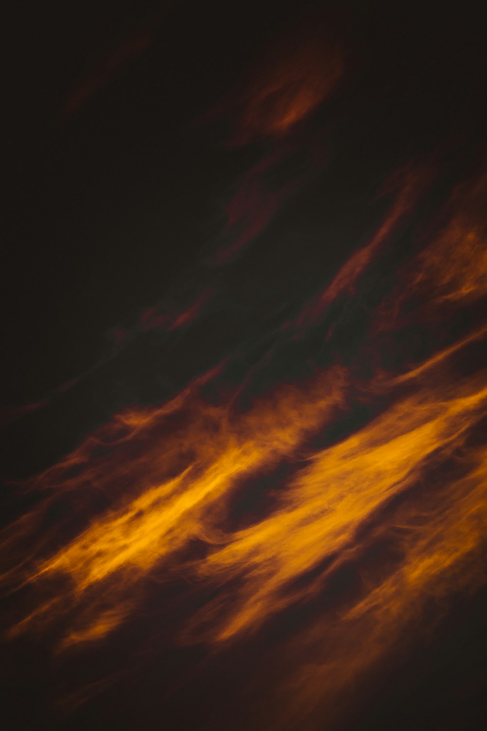 a plane flying through a cloudy sky at night