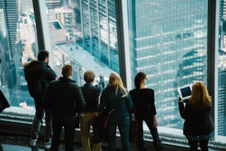 group of people in building looking outside