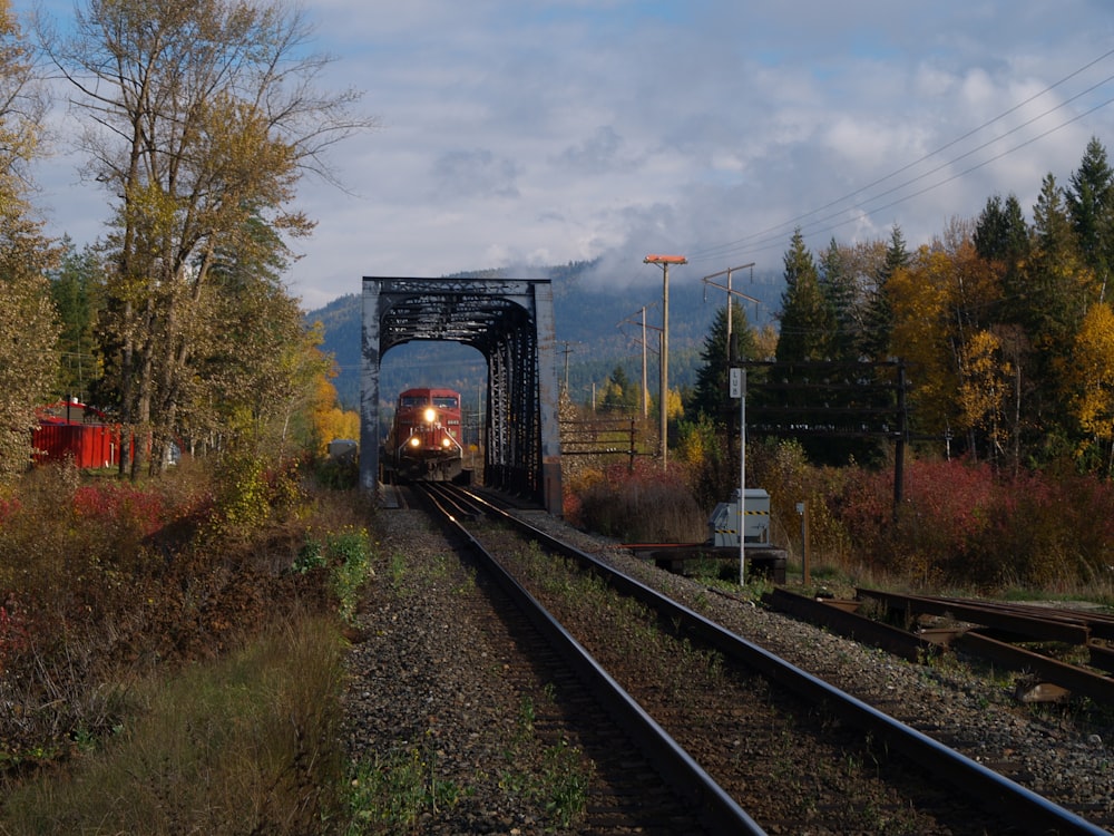 red train on railway