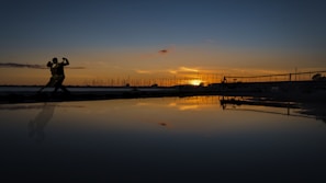 A couple dancing bachata under a beautiful sunset.