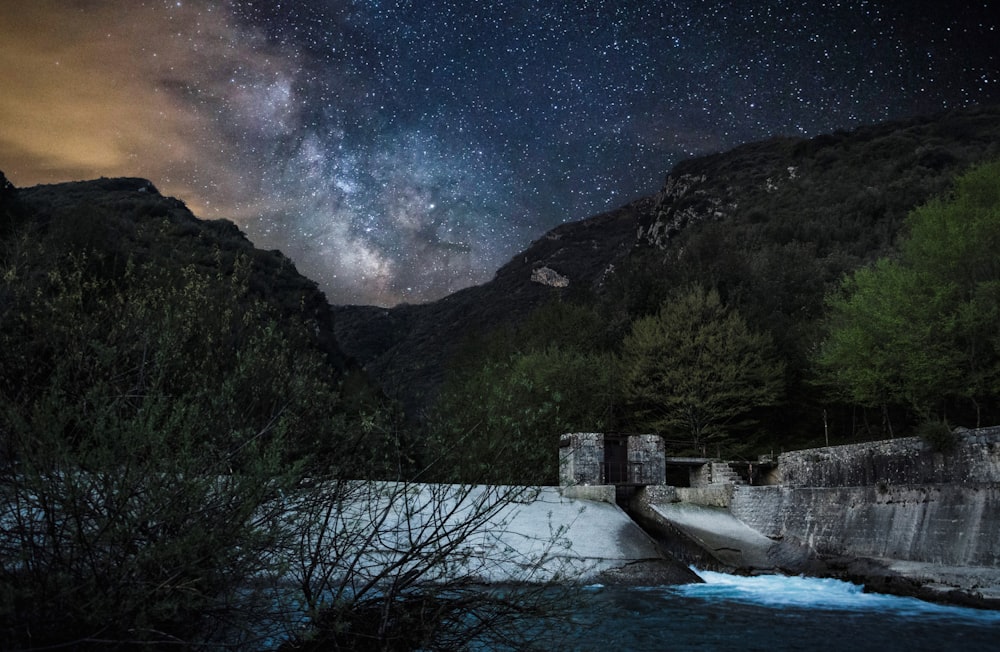 dam near mountain at night