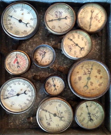 Various industrial gauges and meters with visible wear, waiting for restoration.