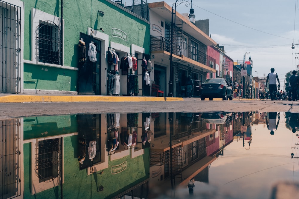 concrete structure reflected on water during daytime