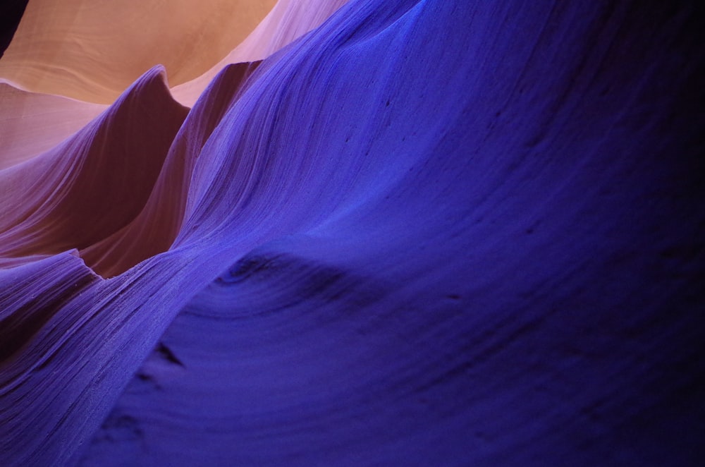 a large rock formation with a blue light in the background