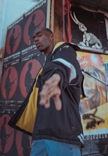 man wearing jacket near wall in room