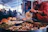 A man cooking Sonoran food outdoors with a scenic desert background.