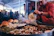 A man cooking Sonoran food outdoors with a scenic desert background.