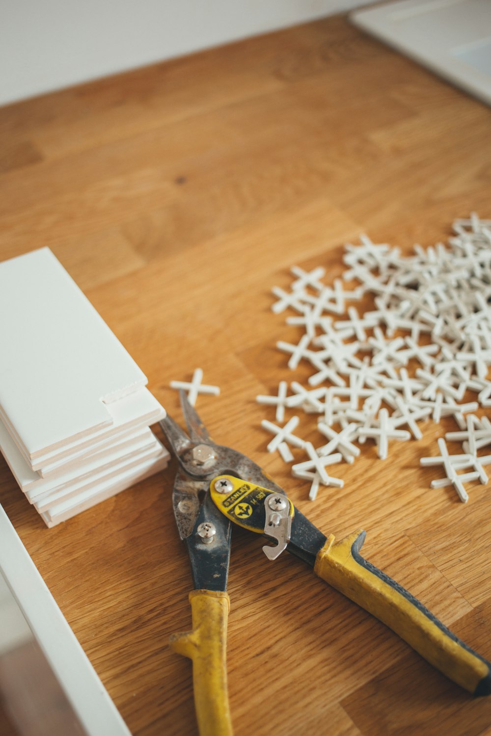 closeup photo of yellow and black handheld tool near white plastic locks