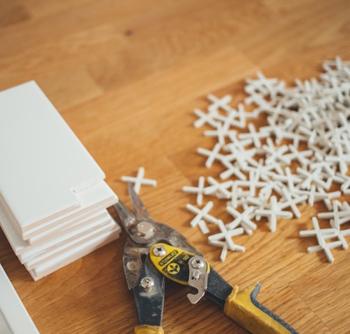 closeup photo of yellow and black handheld tool near white plastic locks