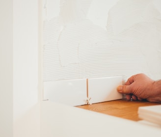 person holding white tile