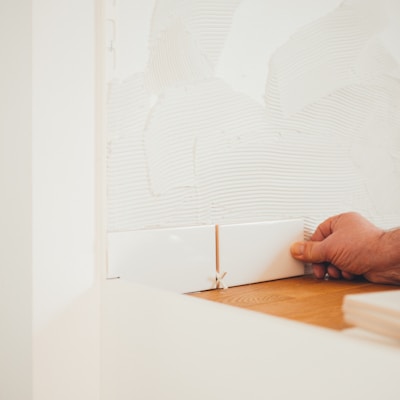 person holding white tile