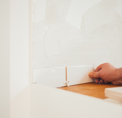 person holding white tile