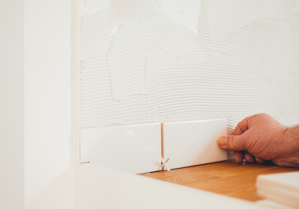 person holding white tile