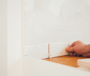 person holding white tile