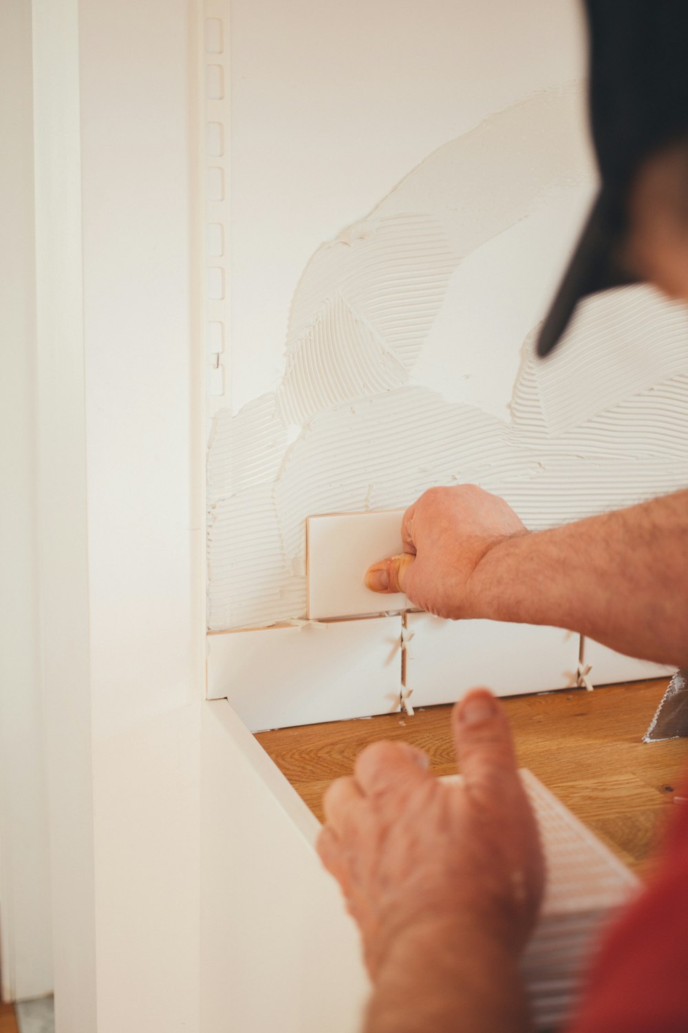 person pressing white wall