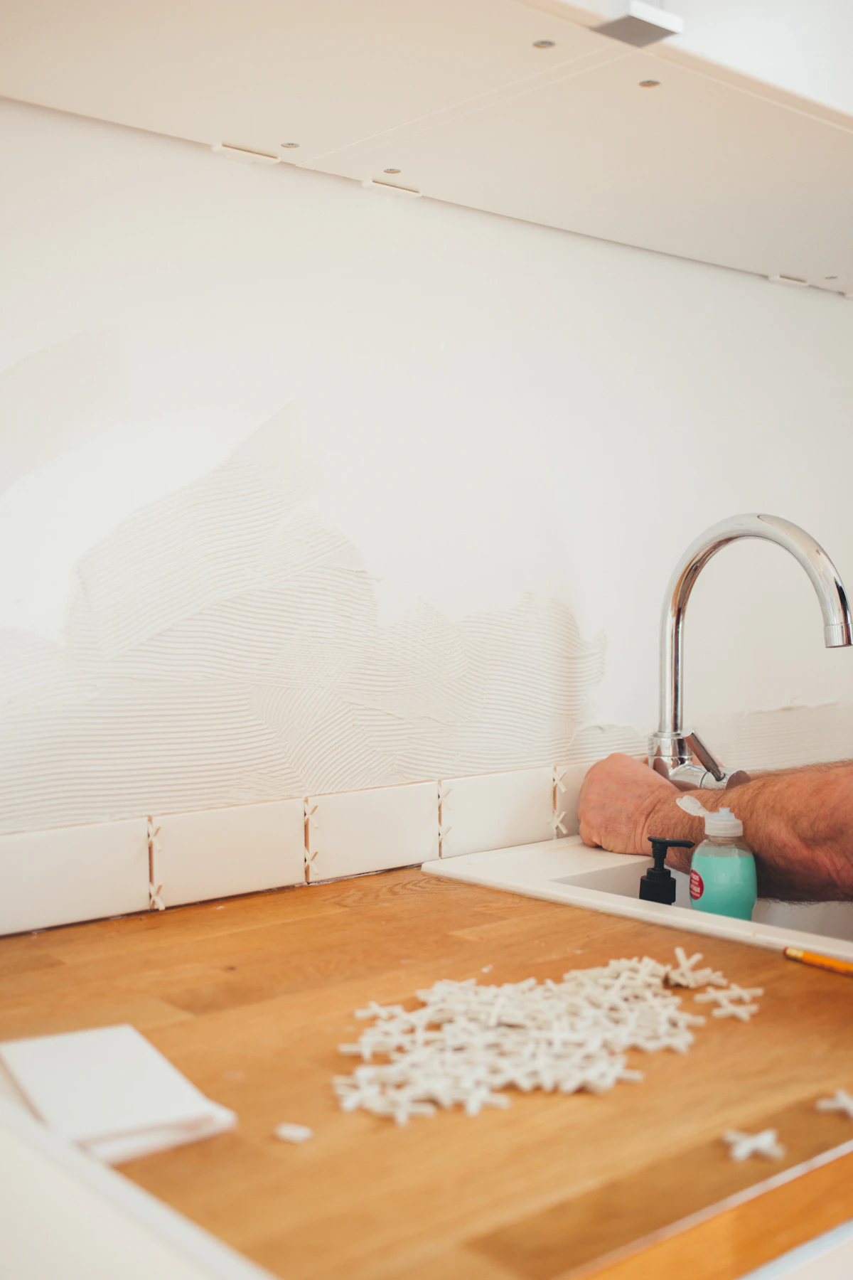 A technician checking hot water flow at a fixture fed by a tankless unit