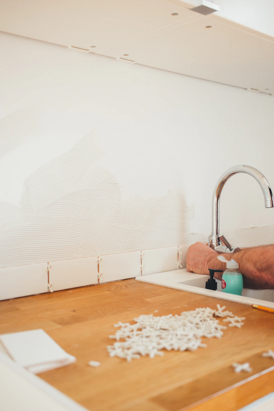 A technician testing hot water temperature and flow at a bathroom fixture right after a tankless changeover