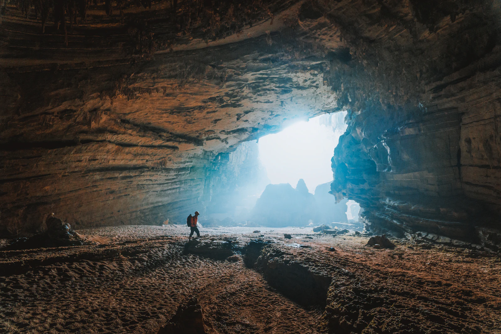 Illuminated limestone formations inside a vast cave chamber in Phong Nha