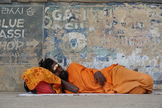 man lying down on street in Varanasi India