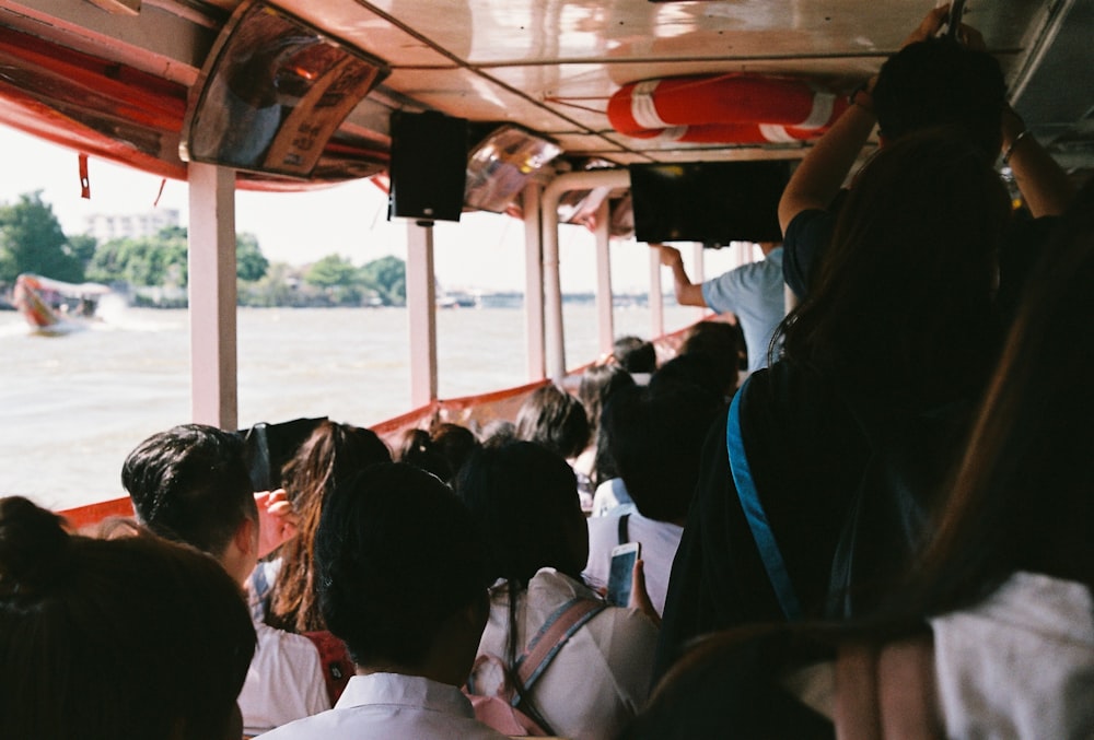 people riding bus during daytime