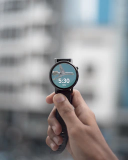 Smartwatch screen showing health stats with a blurred cityscape in the background during golden hour.