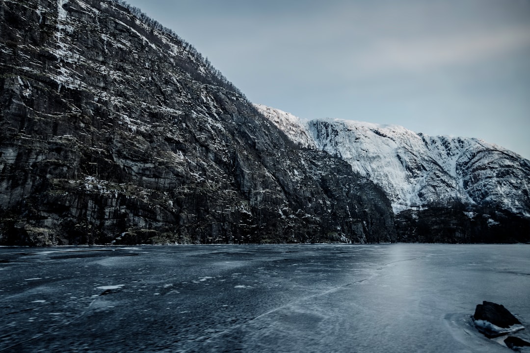 body of water beside mountain