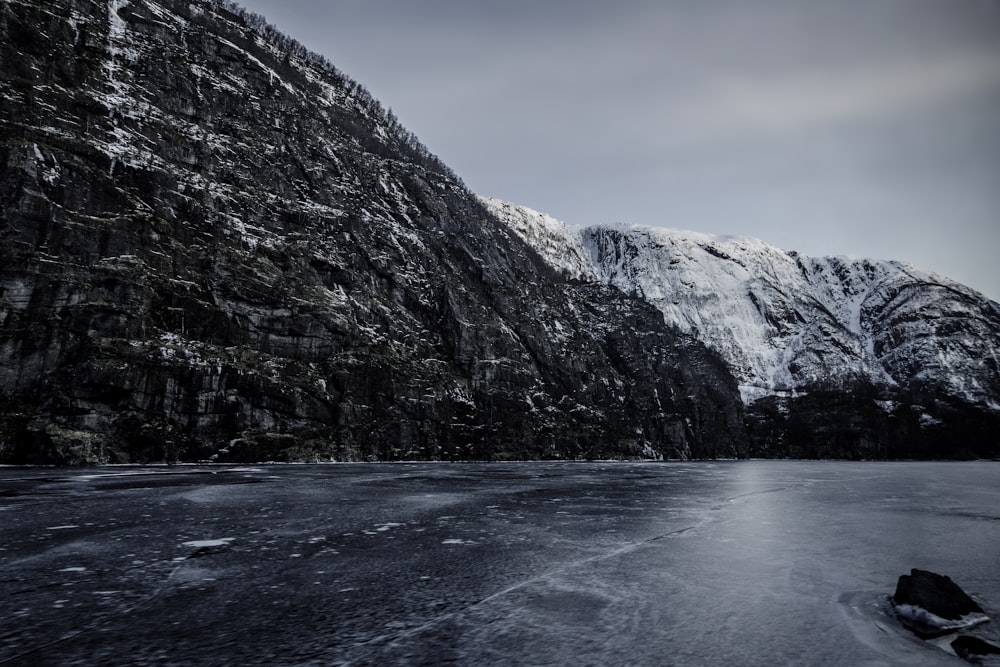 body of water beside mountain