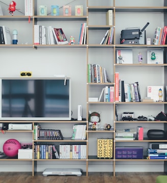 flat screen TV on brown wooden shelf