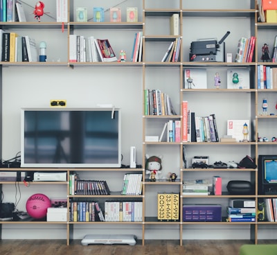 flat screen TV on brown wooden shelf