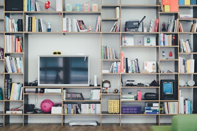 flat screen TV on brown wooden shelf