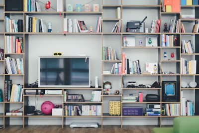flat screen TV on brown wooden shelf