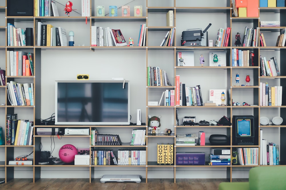 flat screen TV on brown wooden shelf