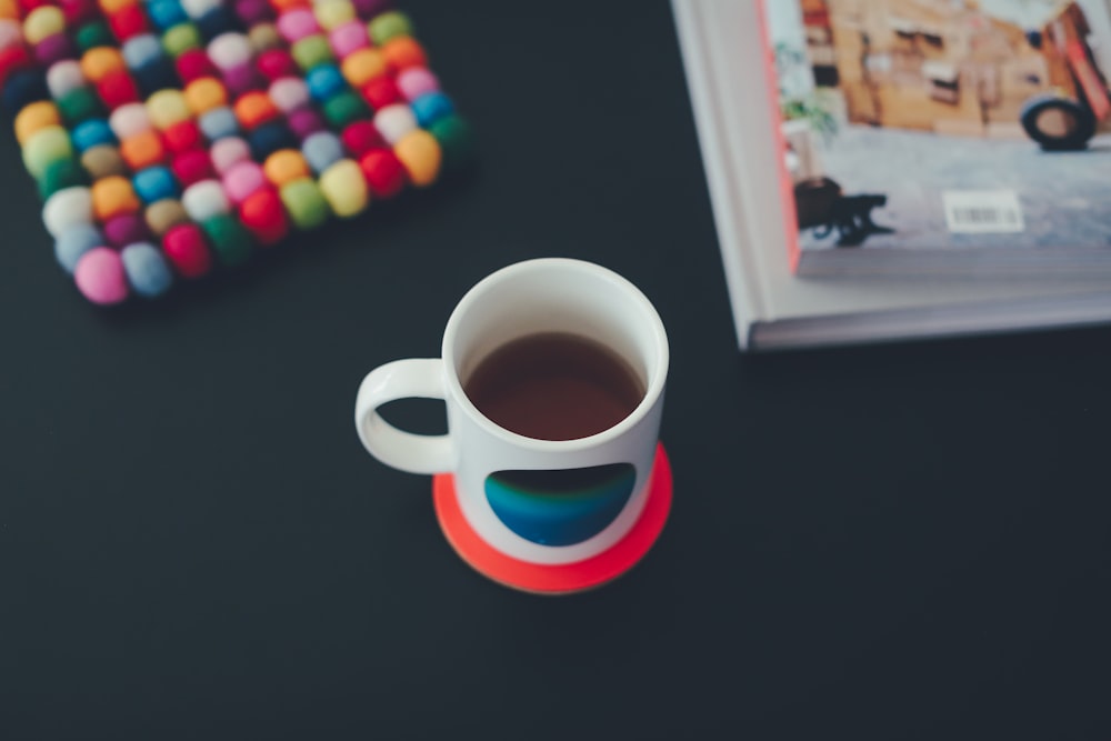 white and blue coffee mug with coffee