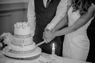 Bride and groom cutting a beautifully decorated wedding cake with mochi accents