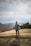 man walking on mountain carrying bag