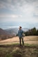 man walking on mountain carrying bag