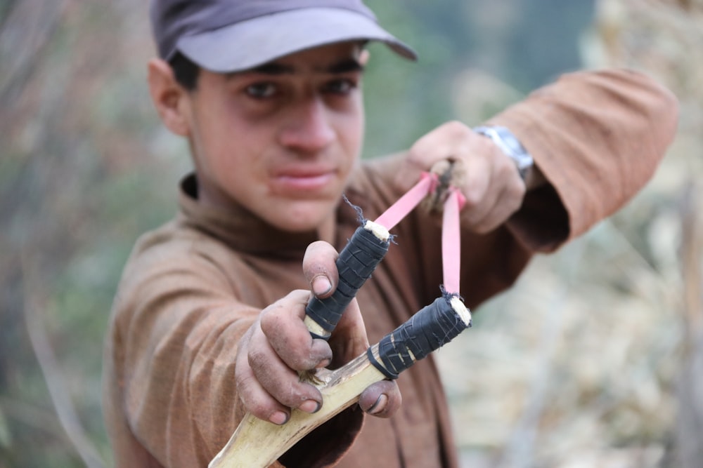 boy using slingshot