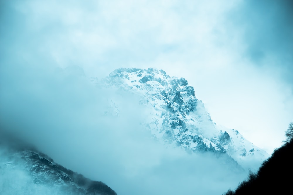 landscape photography of snow-capped mountain covered with fog