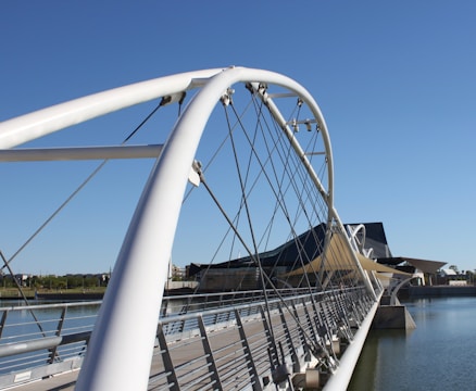 A modern bridge over a river representing the connection between academic institutions and universities.
