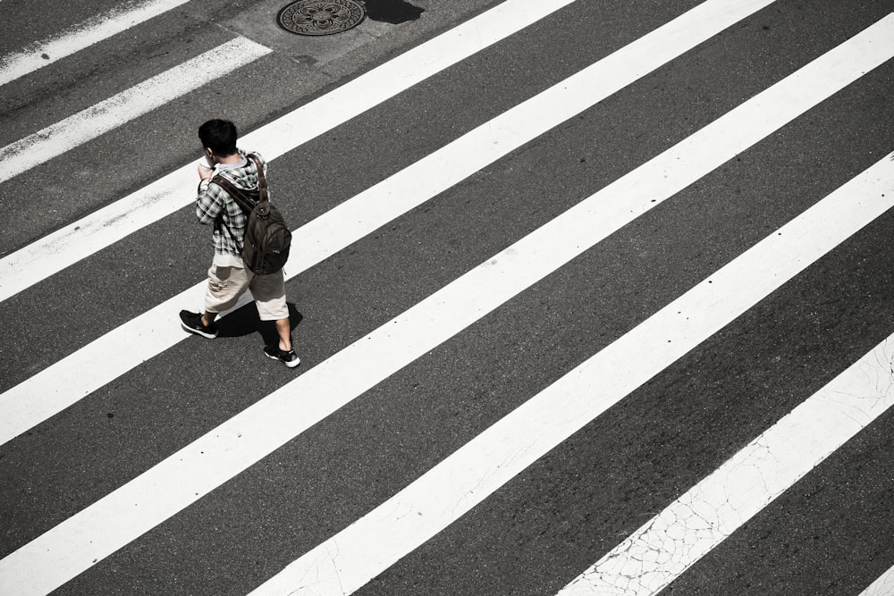 man crossing at pedestrian lane