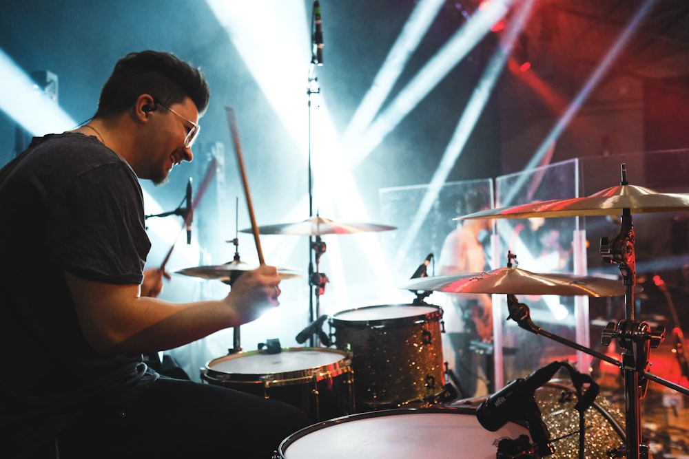 man playing drums on stage