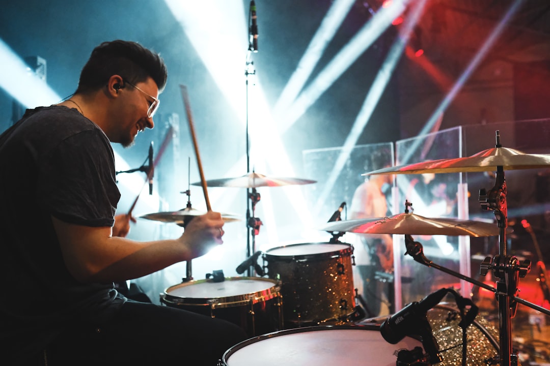man playing drums on stage, give me the beat