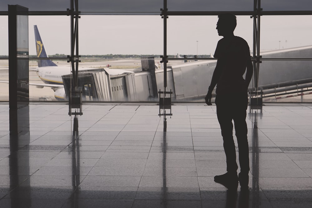 silhouette of man on airport lounge