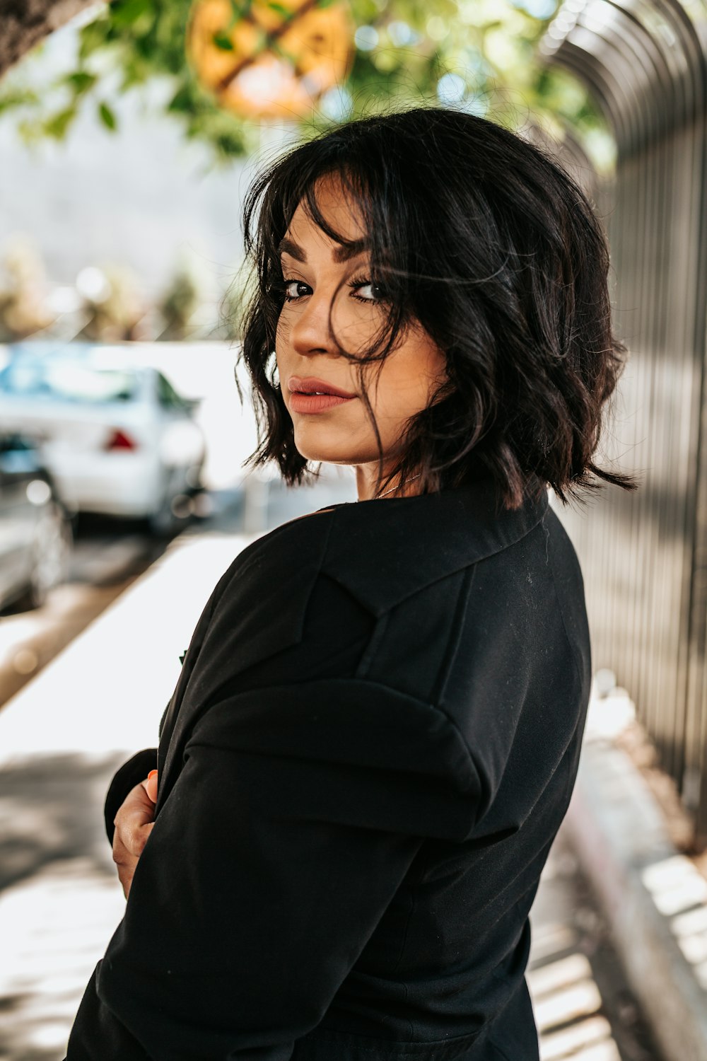 shallow focus photography of woman looking back while walking