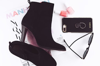 pair of black booties and iPhone 8 Plus