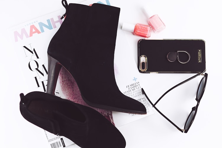 pair of black booties and iPhone 8 Plus