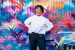 woman standing in front of multicolored wall