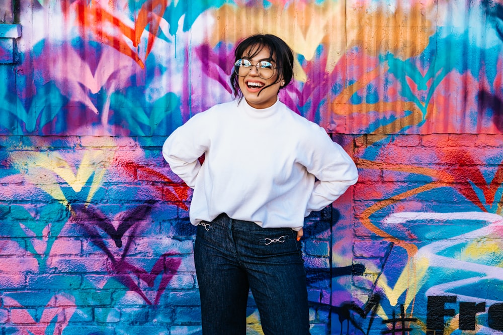 woman standing in front of multicolored wall