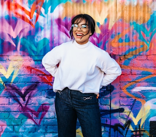 woman standing in front of multicolored wall